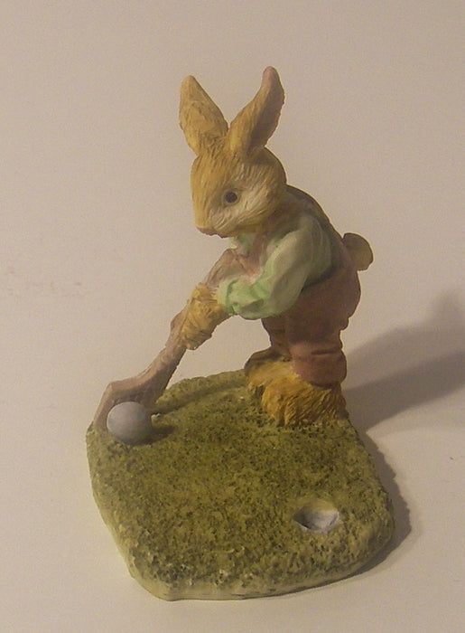 A statue, a rabbit, a golfer