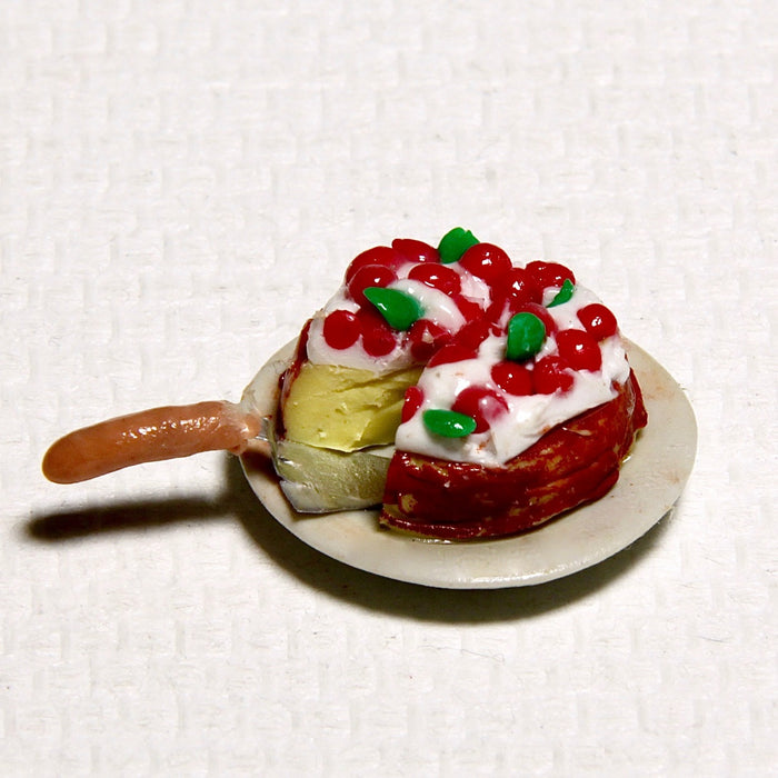 Cream-cherry cake and cake shovel on a plate