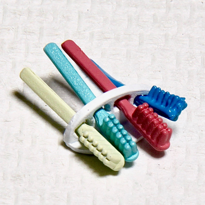 Toothbrushes in a wall holder, white