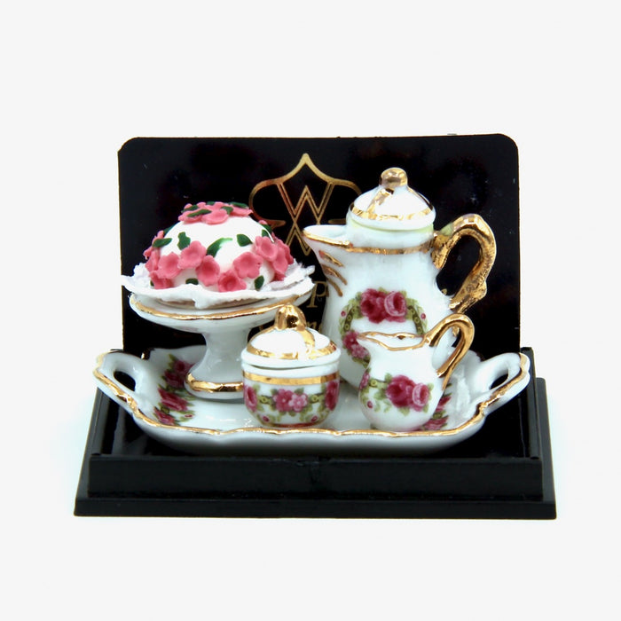 Coffee tableware and rose cake on a tray