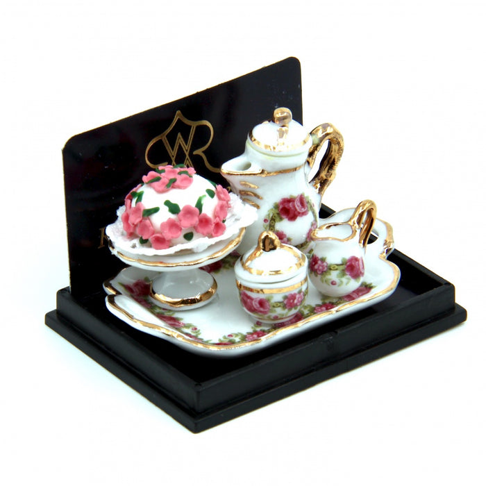 Coffee tableware and rose cake on a tray