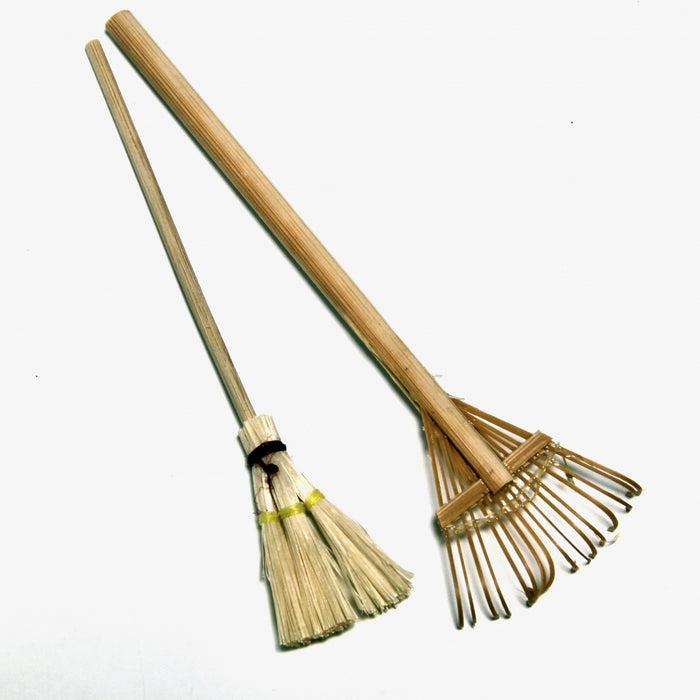 Rake and broom, with a wooden handle