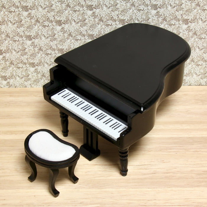 Grand piano and upholstered stool, black