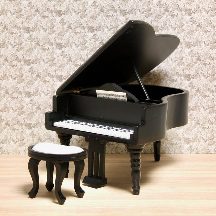 Grand piano and upholstered stool, black