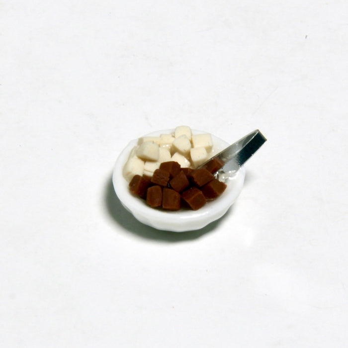 Granulated sugar and sugar tongs in a bowl