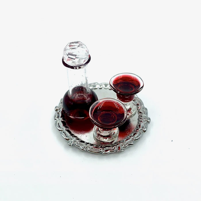 A wine carafe and glasses of red wine on a tray