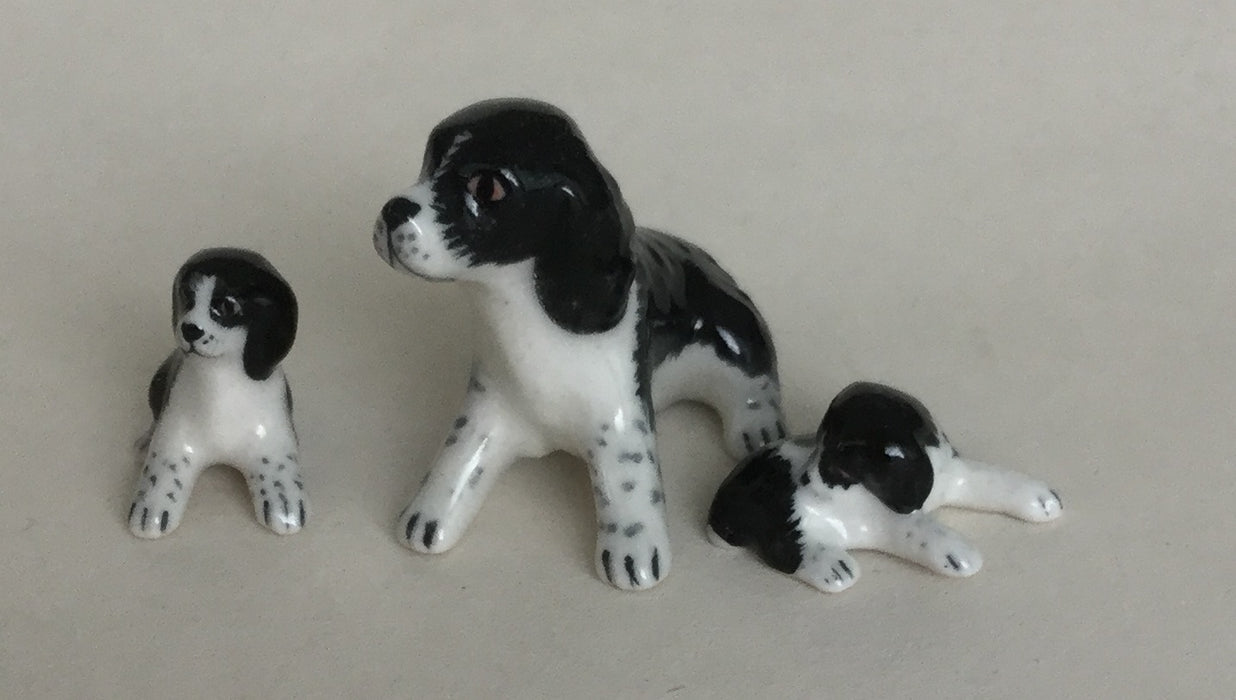 A dog and two puppies, porcelain